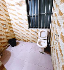 a bathroom with a toilet and a window at W Hotel Sylhet in Sylhet