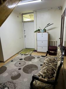 a living room with a couch and a rug at Гостевой дом Энесай in Bishkek