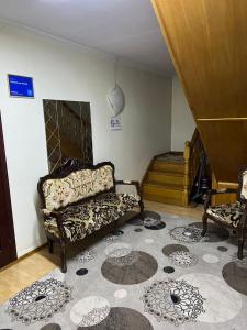 a living room with a couch and two chairs at Гостевой дом Энесай in Bishkek