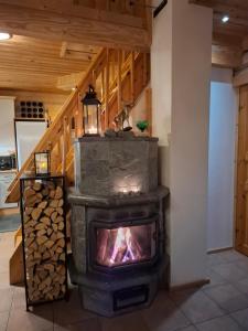 a wood stove in a room with a staircase at Tahko Hovimäenraitti 5A in Tahkovuori
