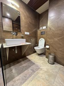 a bathroom with a toilet and a sink at Victory Hotel and Restaurant by GS Hospitality in Shimla