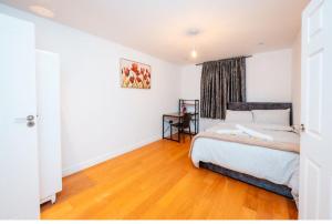 a bedroom with a bed and a wooden floor at Cozy room 1 in Sale