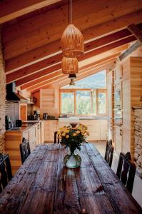 a kitchen with a wooden table with a vase of flowers on it at Espectacular Chalet de Montaña Pirineos, Burg in Burg