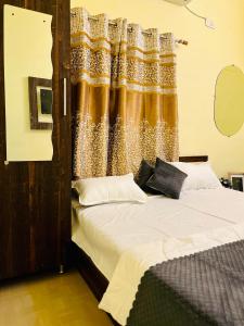 a bedroom with a large bed with a curtain at Heaven hill Pushkar in Pushkar +14 photos