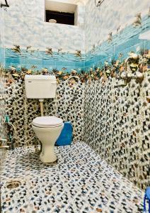 a bathroom with a toilet and birds on the wall at Heaven hill Pushkar in Pushkar