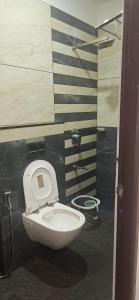 a bathroom with a white toilet in a room at Munnar 4 bedrooms family villa in Munnar