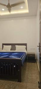 a bedroom with a bed with a blue mattress at Munnar 4 bedrooms family villa in Munnar