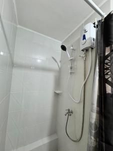 a shower with a shower head in a bathroom at 2-bedroom unit with Sea & Mountain View in Dumaguete +8 photos