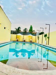 a swimming pool with two chairs and a building at Heaven hill Pushkar in Pushkar