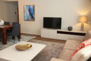 A television and/or entertainment center at LoftAbroad Premium Apartments