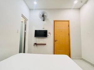 a bedroom with a bed and a tv on the wall at Bona Hostel in Da Nang +16 photos