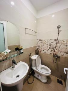 a bathroom with a toilet and a sink at Bona Hostel in Da Nang