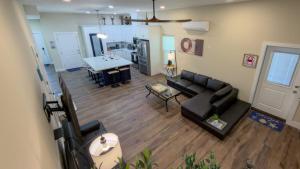 a living room with a black couch and a table at 200 Steps to Beach Private Pool 2 Big Levels apts in South Padre Island