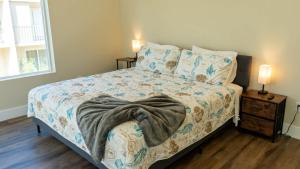 a bedroom with a bed with a blanket on it at 200 Steps to Beach Private Pool 2 Big Levels apts in South Padre Island