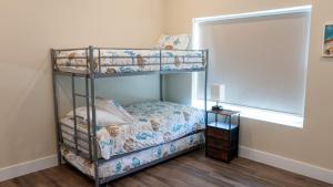 a bedroom with two bunk beds with a window at 200 Steps to Beach Private Pool 2 Big Levels apts in South Padre Island +90 photos