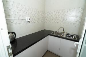 a small kitchen with a sink and a counter at Bona Hostel in Da Nang