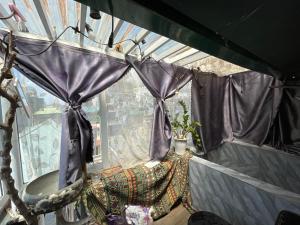 a room with a window with a purple curtain at Ubuntu Sky view 139 Hang Bac in Hanoi