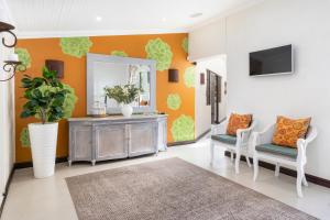 a living room with two chairs and a mirror at The Potting Shed Guest House in Hermanus