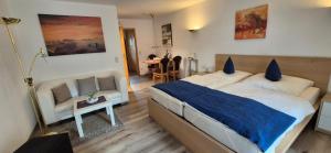 a bedroom with a bed and a chair and a table at Ferienwohnungen Romeo-Julio-Mittenwald in Mittenwald