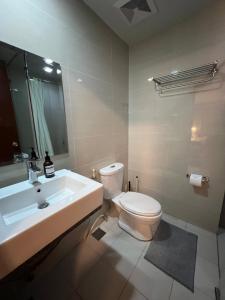 a bathroom with a white toilet and a sink at 1BR - Uptown BGC Taguig in Manila +18 photos