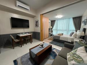 a hotel room with a bed and a living room at 1BR - Uptown BGC Taguig in Manila