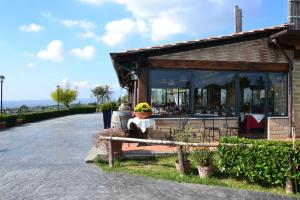 a statue of a person sitting on a bench at Le Due Lune in Cesano