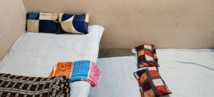 a bed with two pillows on top of it at Rk home stay in Jhūsi