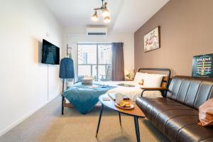 a living room with a bed and a couch at 川HOUSE黒門 in Osaka