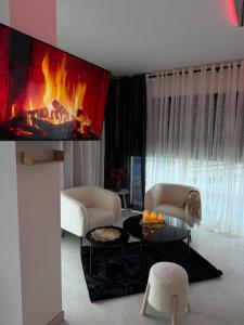 a living room with a fire in the fireplace at Studio de Charme Paris in Rocquencourt