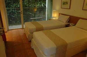 Ένα ή περισσότερα κρεβάτια σε δωμάτιο στο Concordia Hotel Bumi Sangkuriang Bandung