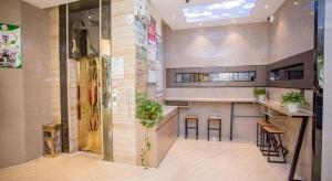 a large kitchen with a counter and some plants at GreenTree Alliance Shenzhen Shekou Sea World Hotel in Shenzhen