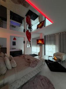 a bedroom with a large bed and a red light at Studio de Charme VERSAILLES in Versailles +169 photos
