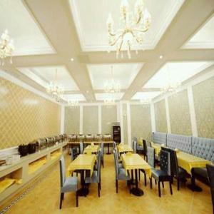 a dining room with tables and chairs and a chandelier at Vienna International Shanghai Nanxiang in Chenjiahang