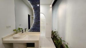 a bathroom with a sink and a mirror at Bnaya Villas Riverside in Amed +22 photos