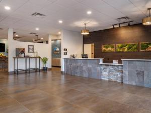 an empty lobby with a reception desk and a counter at The Cranberry, an Ascend Collection Hotel in Morgantown