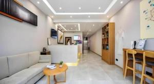 a living room with a couch and a table at GreenTree Inn Ganzi Daochengzhou Scenic Area in Kanggar