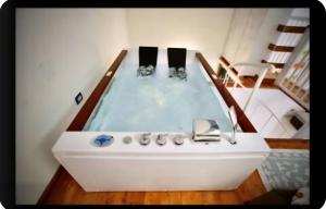a bathtub with two people in it in a room at Maja in Ischia