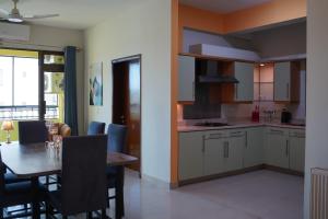 a kitchen and dining room with a table and chairs at Walk-Inn Apartments F-11 Islamabad in Islamabad