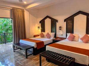 Postel nebo postele na pokoji v ubytování Sundaras Infinity Jungle Resort & Spa