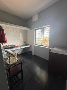 an empty kitchen with a table and a window at ROB'S INN Groupstay  +19 photos