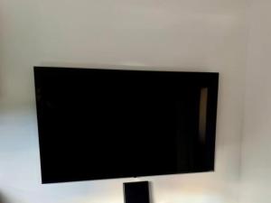 a flat screen tv hanging on a wall at Two-Bedroom Apartment With Terrace in Sreser