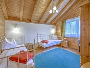 a bedroom with two bunk beds and a window at Holiday Village Wildschönau Traditional Chalet in Niederau