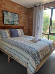 Ένα ή περισσότερα κρεβάτια σε δωμάτιο στο Kunjani - a touch of Africa in the Heart of Kiama