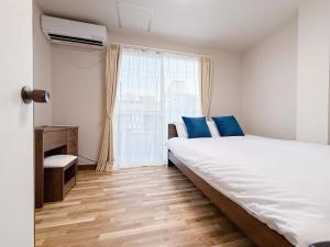 Postel nebo postele na pokoji v ubytování Shiyuan House 士元戸建て