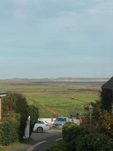 a group of cars parked in a parking lot at Öömrang Dik in Norddorf