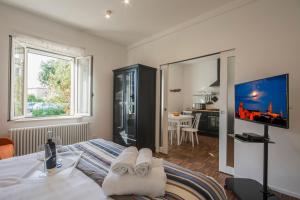 a bedroom with a bed and a living room at La Coroncina Lodging in Siena