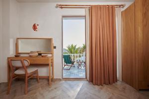 a room with a desk with a mirror and a window at Villa Castelle in Marmaris