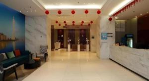 a lobby of a hotel with red balls on the wall at City Comfort Inn Guangzhou Baiyun Mountain in Guangzhou