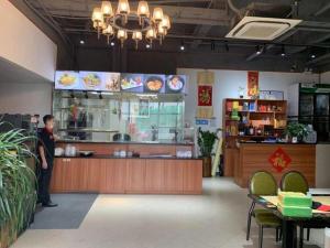 a man standing at the counter of a fast food restaurant at The Art Hotel Cai Tian Branch in Shenzhen