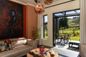 a living room with a couch and a table at Kunjani Villas & Wines in Stellenbosch